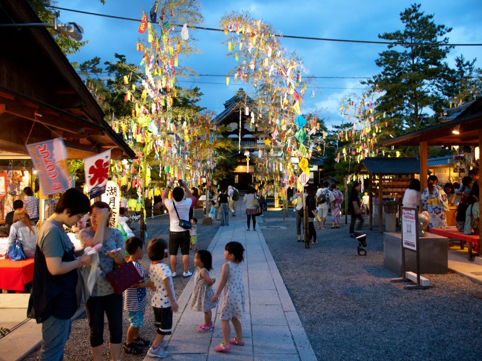 Bamboo covered with strips of paper with wishes written on them line the path to at Kōdai-ji temple.