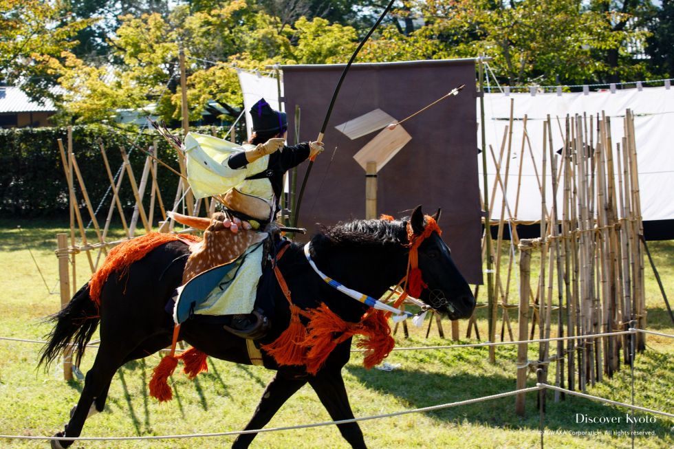 A rider aims for a large wooden target during the Kasagake Shinji at Kamigamo Shrine.