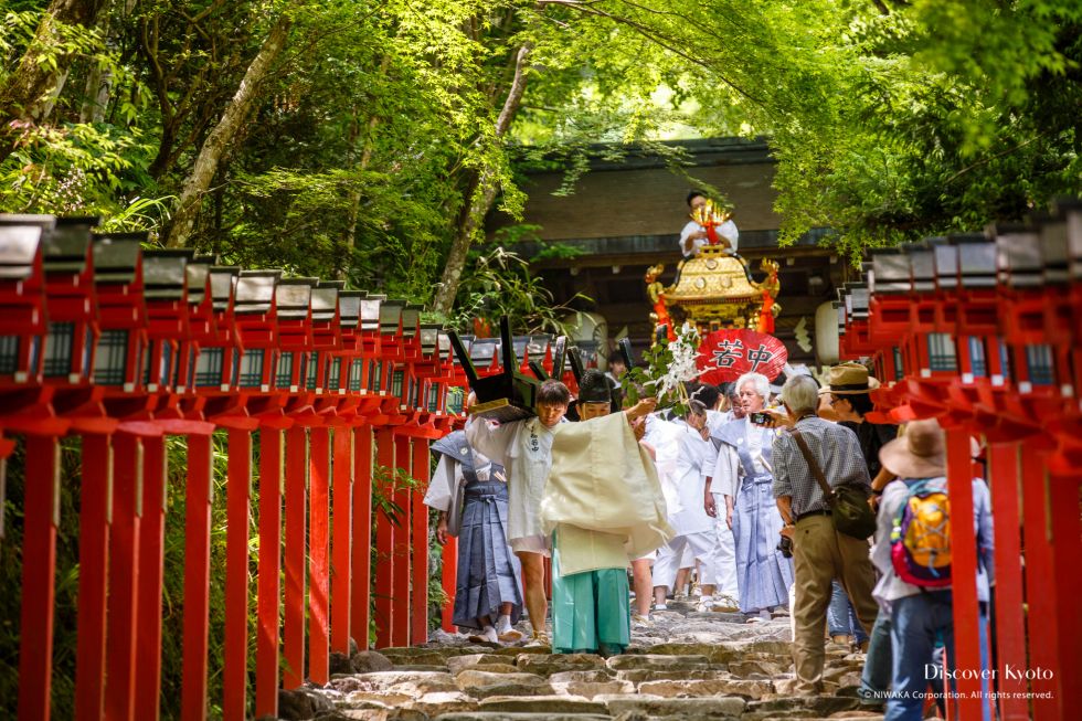 A priest cleanses the path during Kifune Matsuri at Kifune Shrine.