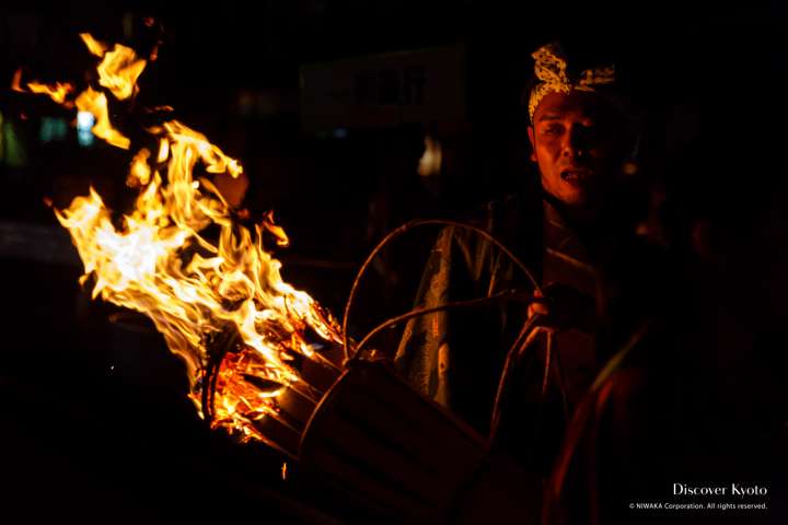 Local men carry heavy torches during the Kurama no Hi Matsuri at Yuki Shrine.