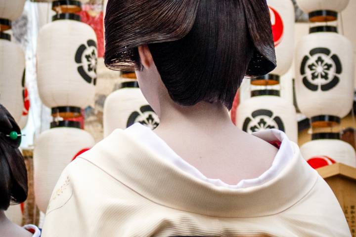 A geiko and lanterns during the Yoiyama nights of Gion Matsuri.