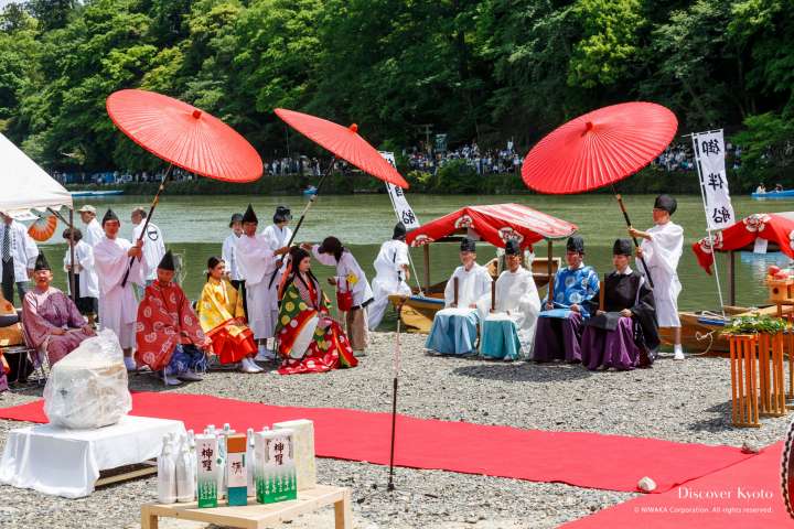 Large umbrellas provide shade at Mifune Matsuri at Kurumazaki Jinja.