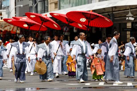 Men carrying umbrellas during the Yamaboko Junkō parade of the Gion Matsuri.