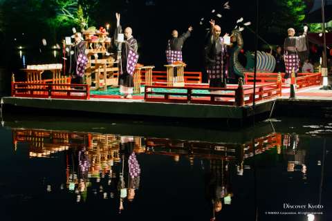 Moon-shaped wishing papers flung in the pond at the Kangetsu no Yūbe at Daikaku-ji.
