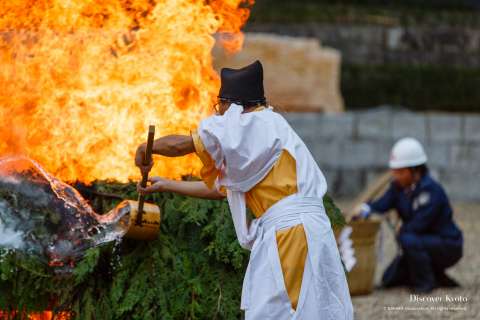 Assistants control the blaze during the Hitaki-sai Fire Festival at Fushimi Inari.