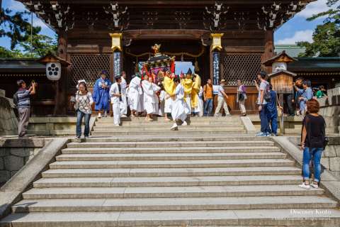 The portable shrine procession departs the shrine during the Zuiki Matsuri at Kitano Tenmangū.