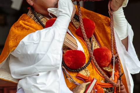 A shugendō priest blows a conch shell during the Aki Matsuri at Tanukidani-san Fudō-in.