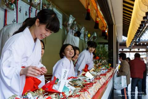 Buying charms at Tōka Ebisu at Kyoto Ebisu Shrine.