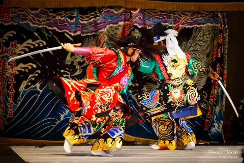 Two gods fighting with swords during the Iwami Kagura at Yasaka Shrine.