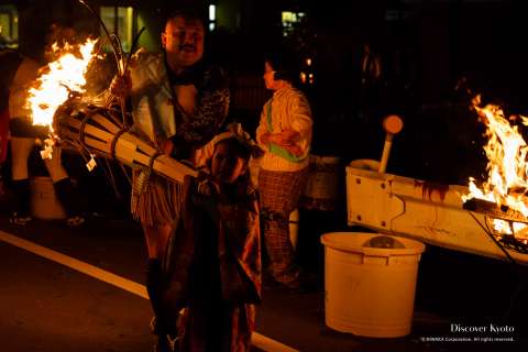 Local children carry mini torches participate in the Kurama no Hi Matsuri at Yuki Shrine.